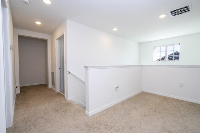 empty room with light colored carpet