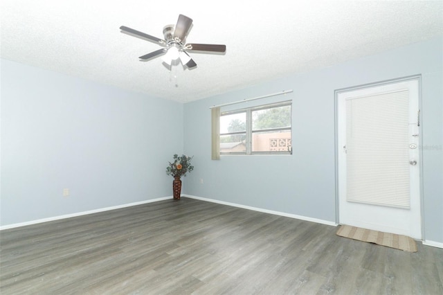 unfurnished room featuring dark hardwood / wood-style flooring, a textured ceiling, and ceiling fan