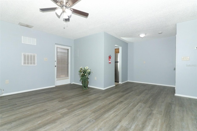 unfurnished room with ceiling fan, dark hardwood / wood-style flooring, and a textured ceiling