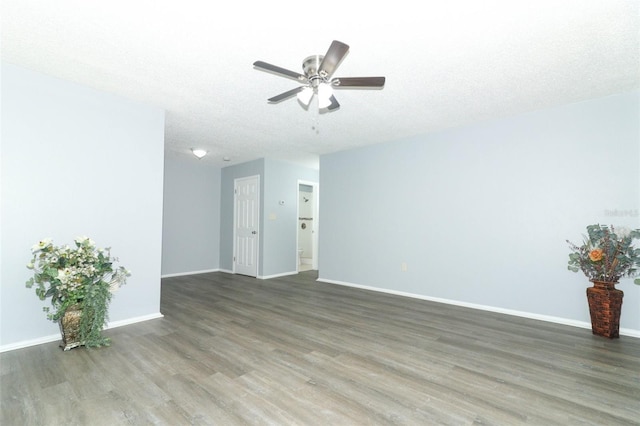 unfurnished room with ceiling fan, a textured ceiling, and dark wood-type flooring