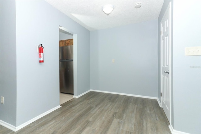 empty room featuring hardwood / wood-style floors and a textured ceiling