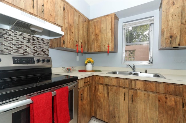 kitchen with backsplash, electric range, and sink