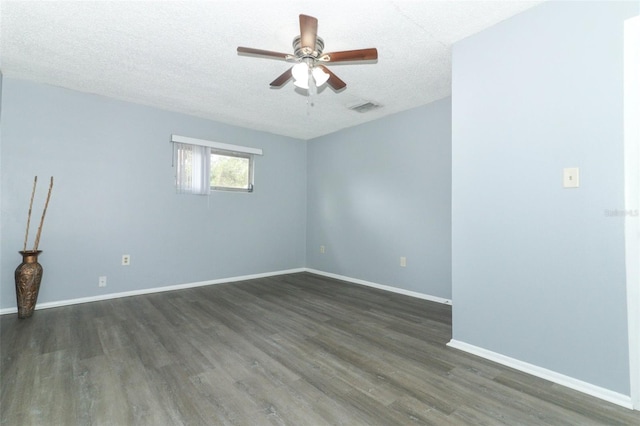 empty room with dark hardwood / wood-style floors, ceiling fan, and a textured ceiling