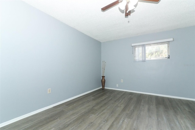 spare room featuring dark hardwood / wood-style floors, ceiling fan, and a textured ceiling