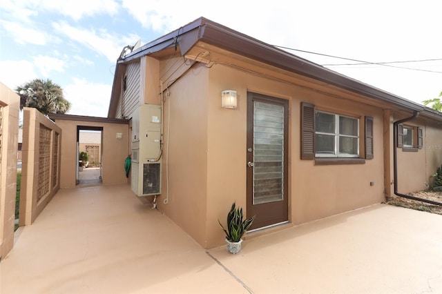 view of side of property with a patio