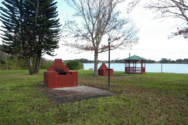 view of yard featuring a gazebo and a water view