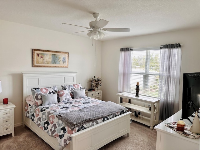 bedroom featuring light colored carpet, ceiling fan, and a textured ceiling