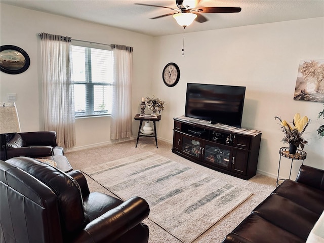 living room featuring baseboards, ceiling fan, and carpet flooring