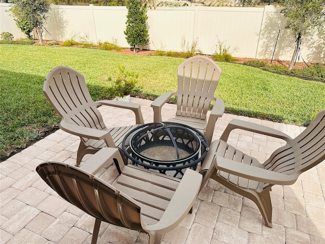 view of patio / terrace with a fire pit and fence