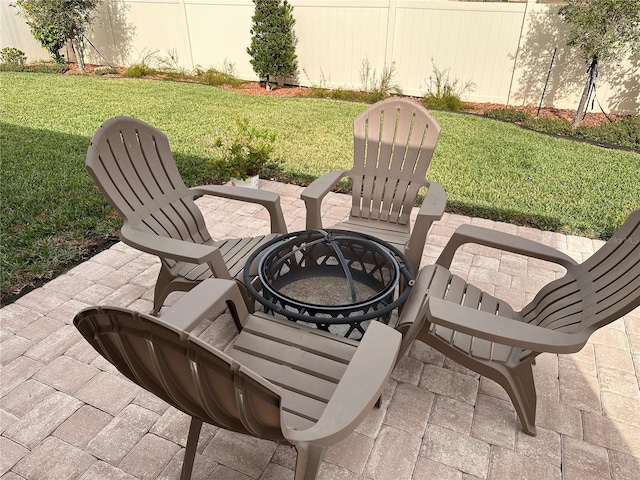 view of patio featuring fence and an outdoor fire pit