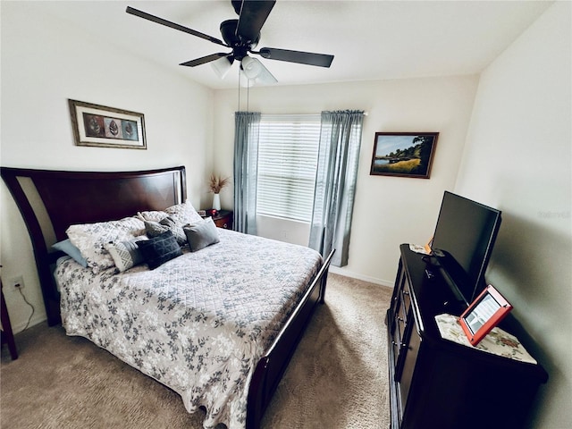 carpeted bedroom with baseboards and a ceiling fan