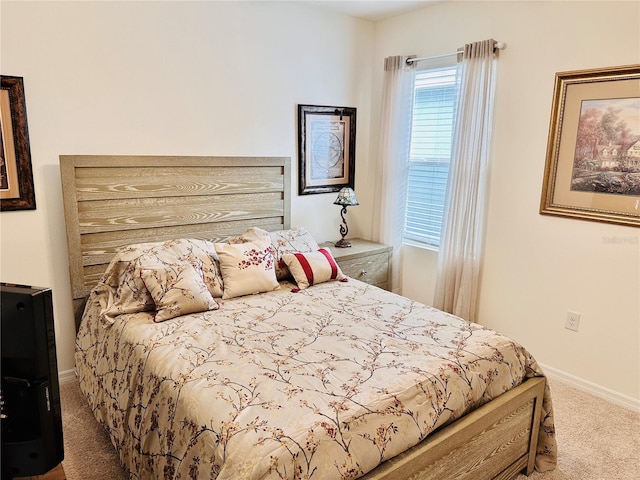 carpeted bedroom featuring baseboards