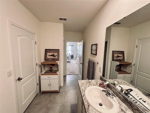 bathroom with visible vents, vanity, and tile patterned flooring