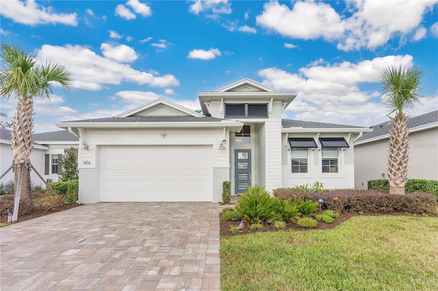 view of front of home with a front lawn and a garage