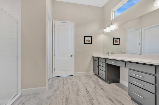 bathroom with vanity, wood-type flooring, and walk in shower