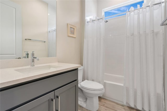 full bathroom with toilet, vanity, shower / tub combo, and hardwood / wood-style flooring