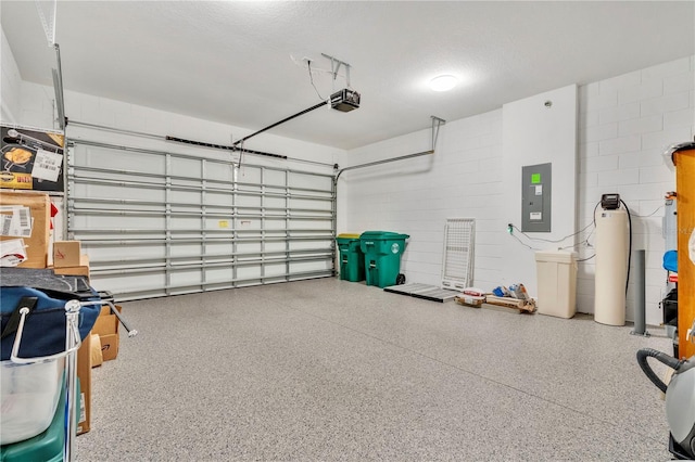 garage featuring electric panel and a garage door opener