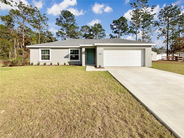 single story home with a garage and a front lawn