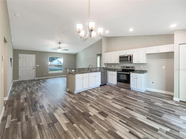 kitchen featuring kitchen peninsula, pendant lighting, white cabinets, ceiling fan with notable chandelier, and appliances with stainless steel finishes