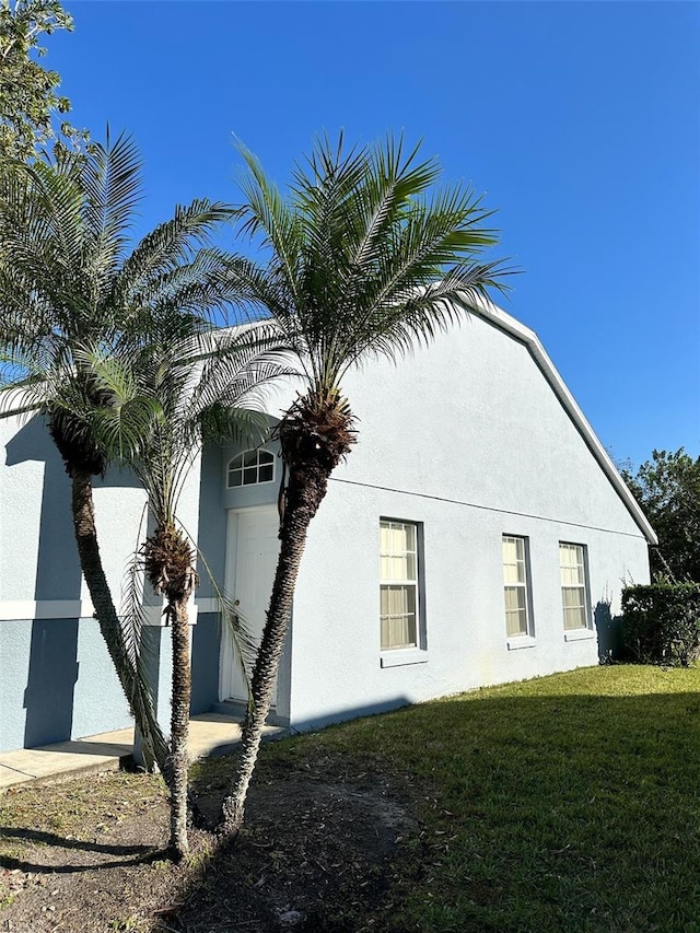 view of side of home featuring a lawn