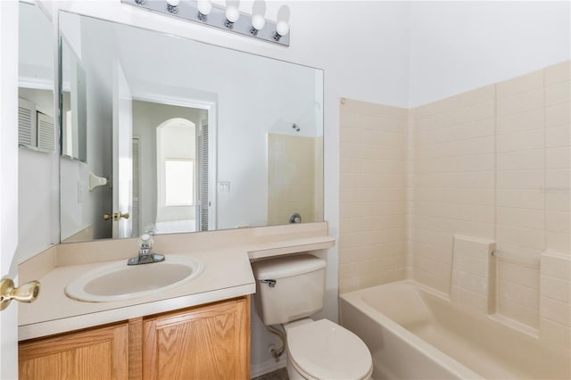 bathroom featuring vanity, toilet, and washtub / shower combination