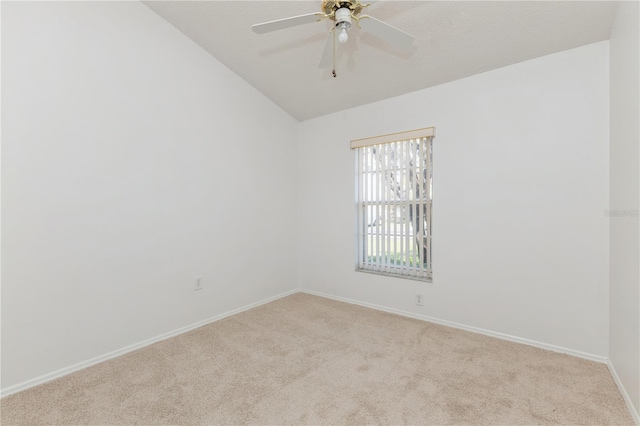 unfurnished room with baseboards, lofted ceiling, carpet, and a ceiling fan