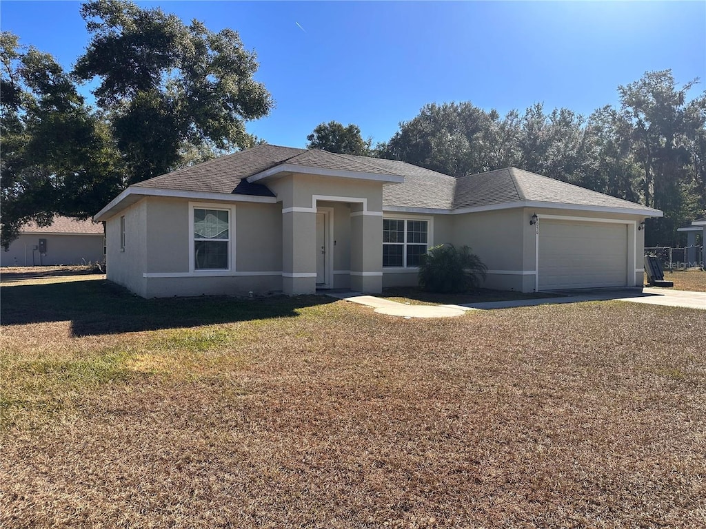 view of front of home with a front lawn and a garage