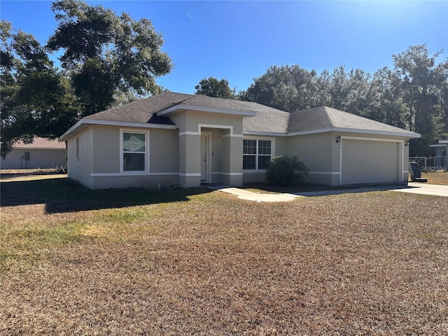 view of front of home with a front lawn and a garage