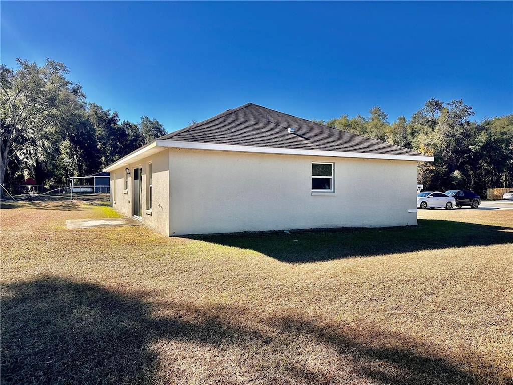 view of side of property with a yard