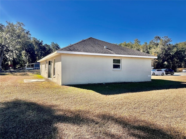 view of side of property with a yard