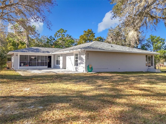 back of house featuring a lawn and a patio area