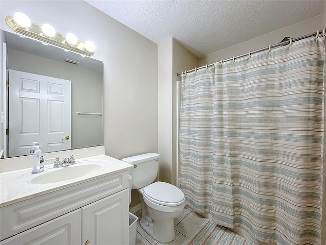 bathroom featuring tile patterned floors, walk in shower, a textured ceiling, vanity, and toilet