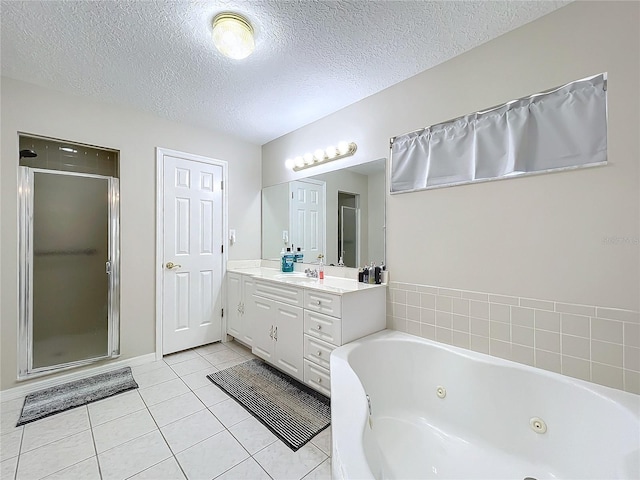 bathroom with tile patterned floors, vanity, independent shower and bath, and a textured ceiling