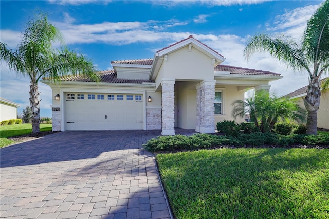 mediterranean / spanish-style home featuring a garage and a front yard