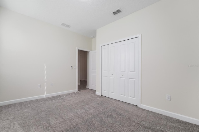 unfurnished bedroom featuring carpet floors and a closet