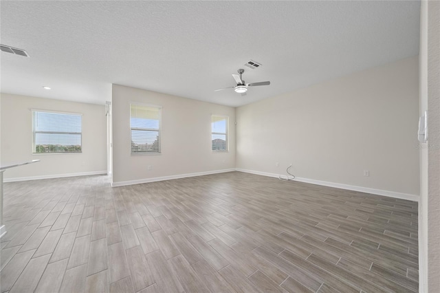 spare room featuring a textured ceiling and ceiling fan