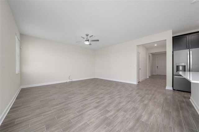 spare room with ceiling fan, hardwood / wood-style floors, and a textured ceiling