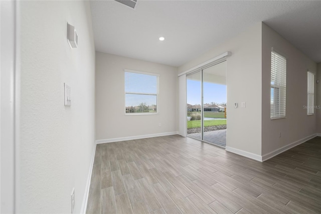 spare room with light hardwood / wood-style floors