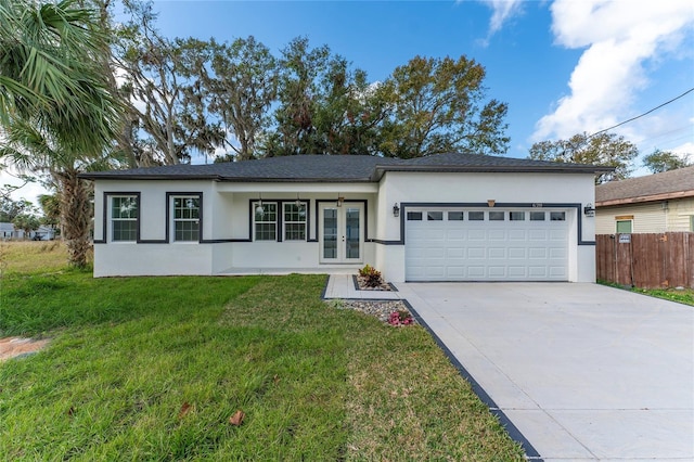 single story home featuring a front yard, french doors, and a garage