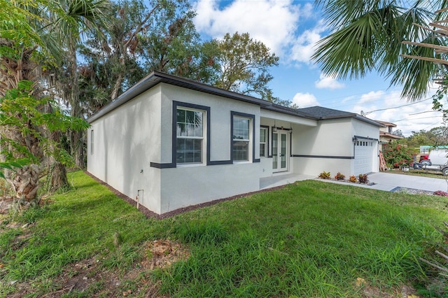 view of property exterior with a garage and a lawn