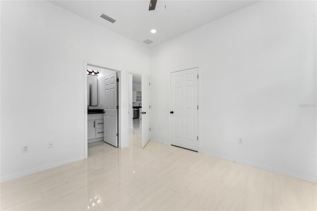 unfurnished room with ceiling fan, light tile patterned flooring, and a high ceiling