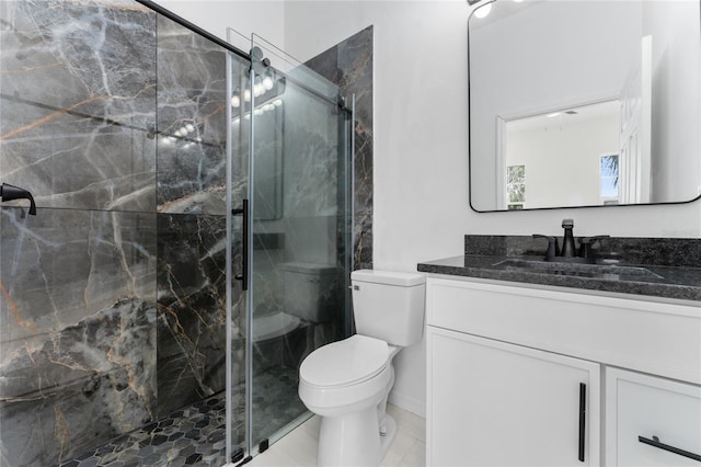 bathroom featuring vanity, an enclosed shower, and toilet