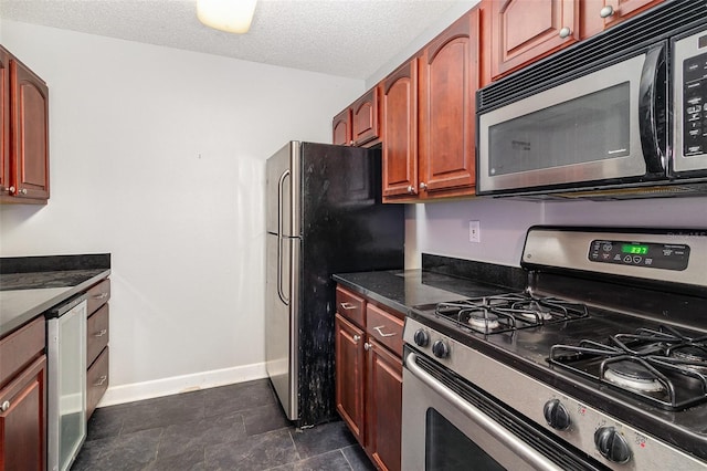 kitchen with a textured ceiling and appliances with stainless steel finishes