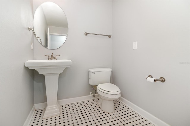 bathroom featuring tile patterned flooring and toilet