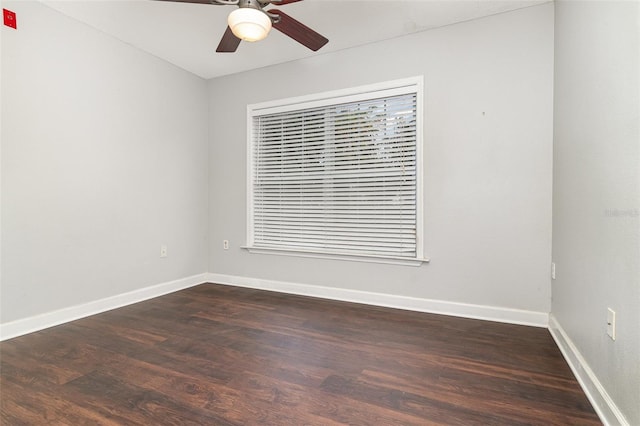 unfurnished room with dark hardwood / wood-style flooring and ceiling fan