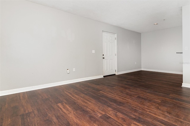 empty room with dark wood-type flooring