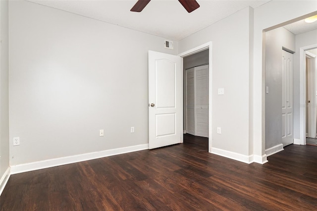 unfurnished bedroom featuring ceiling fan and dark hardwood / wood-style floors