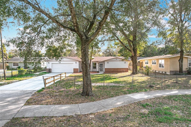 ranch-style home featuring concrete driveway, a front lawn, a fenced front yard, and a residential view