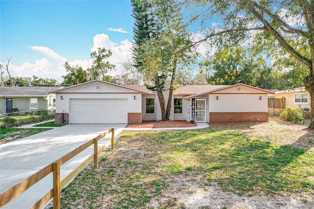 ranch-style home with driveway, fence, and brick siding