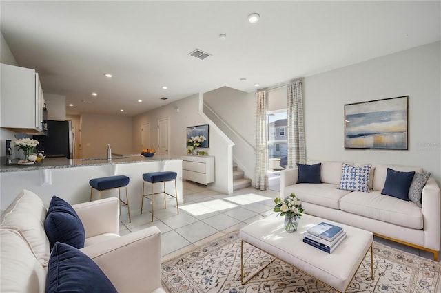 living room with sink and light tile patterned floors